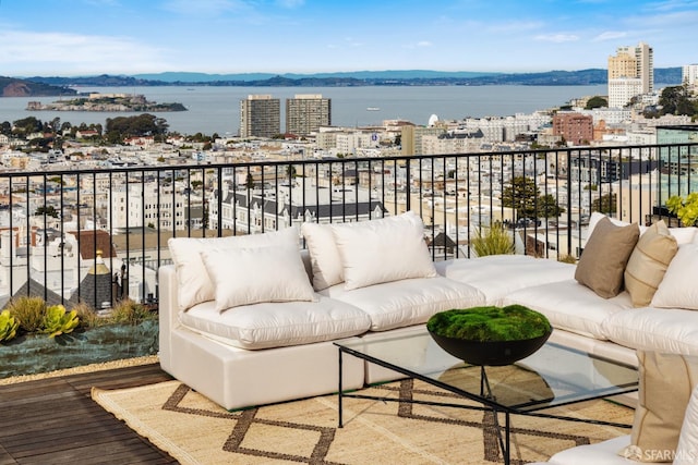balcony with an outdoor living space and a view of city