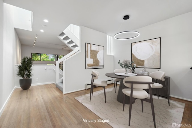 120 Landers St Unit D, San Francisco, CA 94114 - dining area featuring stairs, wood finished floors, a baseboard radiator, and baseboards