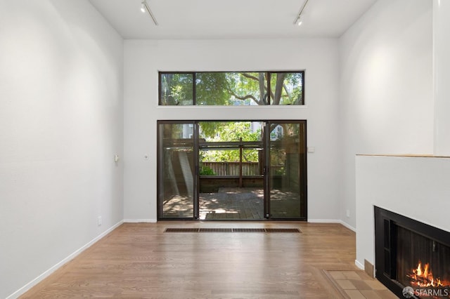 120 Landers St Unit D, San Francisco, CA 94114 - foyer entrance with track lighting, a fireplace with flush hearth, wood finished floors, and baseboards