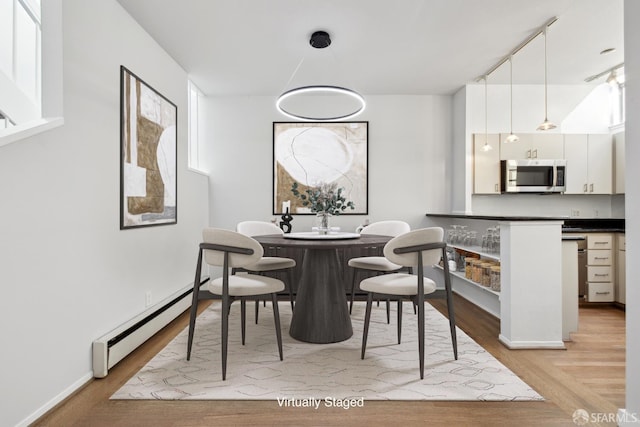 120 Landers St Unit D, San Francisco, CA 94114 - dining space featuring baseboard heating, light wood-style flooring, and baseboards