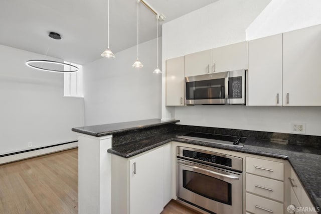 120 Landers St Unit D, San Francisco, CA 94114 - kitchen featuring appliances with stainless steel finishes, a peninsula, wood finished floors, a baseboard heating unit, and dark stone countertops