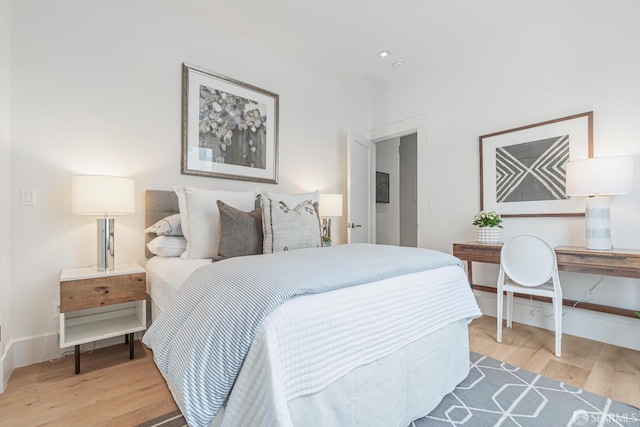 bedroom with wood finished floors and baseboards