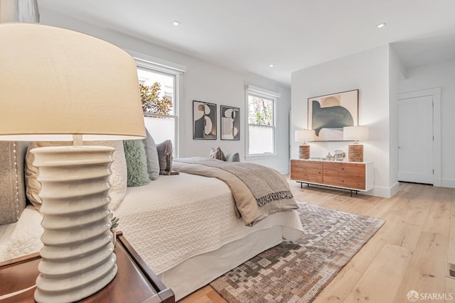 bedroom featuring recessed lighting, baseboards, and wood-type flooring