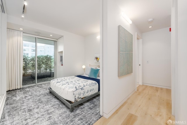 38 Bryant St Unit 405, San Francisco, CA 94105 - bedroom with access to exterior, light wood-style floors, and recessed lighting