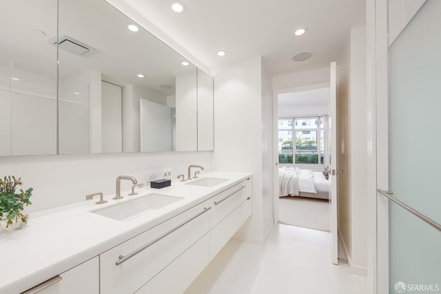 38 Bryant St Unit 405, San Francisco, CA 94105 - ensuite bathroom with double vanity, recessed lighting, baseboards, and tile patterned flooring