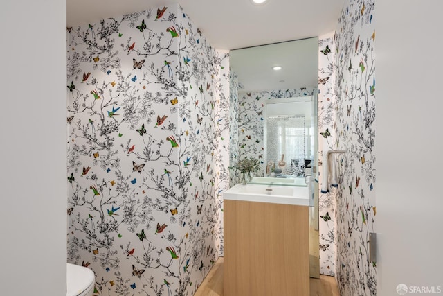 38 Bryant St Unit 405, San Francisco, CA 94105 - bathroom with toilet, wallpapered walls, vanity, and recessed lighting