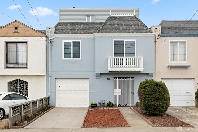 1727 45th Ave, San Francisco, CA 94122 - view of property featuring a shingled roof, an attached garage, stucco siding, concrete driveway, and a balcony