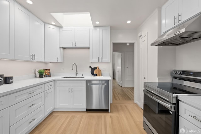 1727 45th Ave, San Francisco, CA 94122 - kitchen with appliances with stainless steel finishes, under cabinet range hood, recessed lighting, light wood-type flooring, and white cabinetry