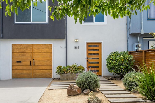 1515 Van Dyke Ave, San Francisco, CA 94124 - view of front of property with an attached garage, stucco siding, and driveway