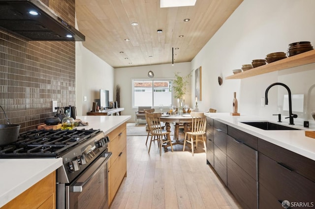 1515 Van Dyke Ave, San Francisco, CA 94124 - kitchen featuring gas range oven, wall chimney exhaust hood, light countertops, open shelves, and recessed lighting