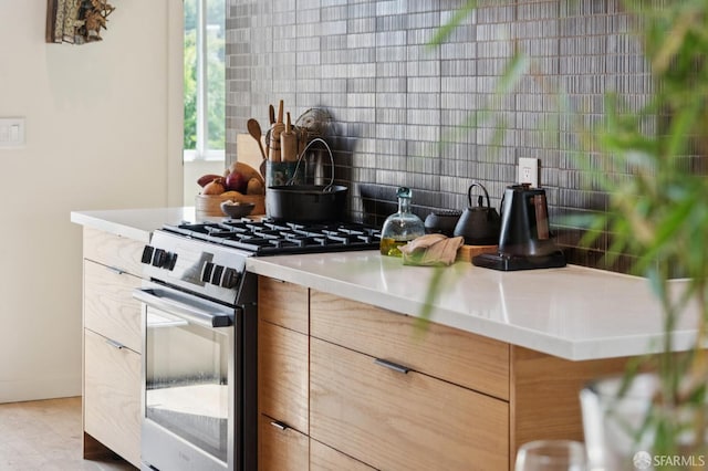 1515 Van Dyke Ave, San Francisco, CA 94124 - kitchen with stainless steel gas stove, tasteful backsplash, modern cabinets, and light countertops