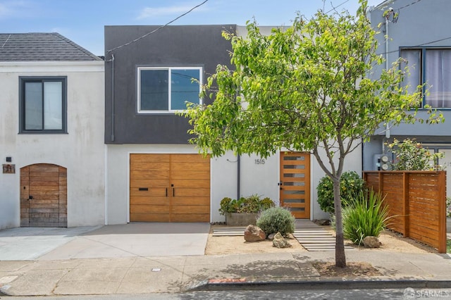 1515 Van Dyke Ave, San Francisco, CA 94124 - contemporary home featuring an attached garage, concrete driveway, stucco siding, and a shingled roof