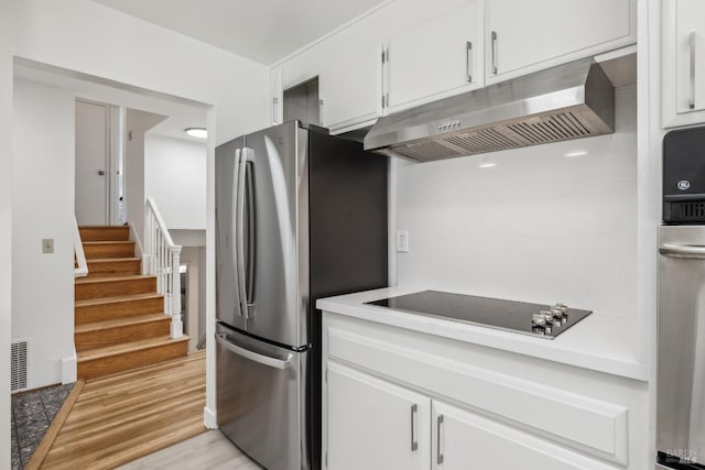 7 Hearthstone Ct, San Rafael, CA 94903 - kitchen featuring under cabinet range hood, freestanding refrigerator, black electric cooktop, and white cabinetry