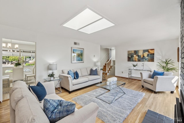 7 Hearthstone Ct, San Rafael, CA 94903 - living area featuring stairs, a chandelier, light wood-style floors, and a skylight