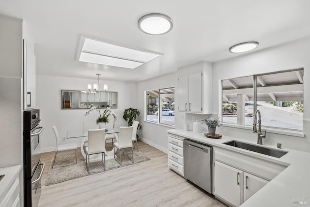 7 Hearthstone Ct, San Rafael, CA 94903 - kitchen with stainless steel dishwasher, a sink, a chandelier, white cabinets, and light wood finished floors