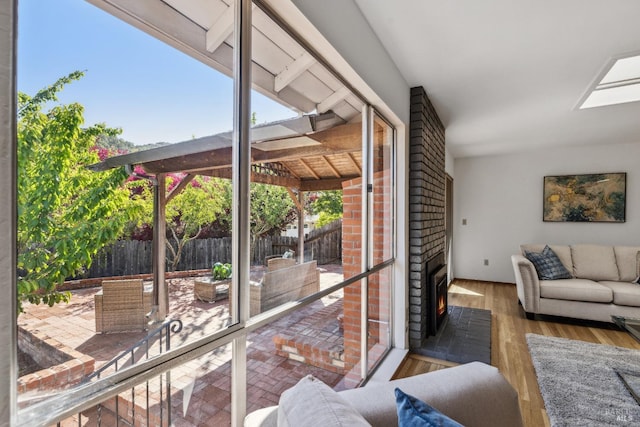 7 Hearthstone Ct, San Rafael, CA 94903 - living room with healthy amount of natural light, an outdoor brick fireplace, and wood finished floors
