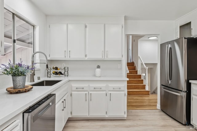 7 Hearthstone Ct, San Rafael, CA 94903 - kitchen with stainless steel appliances, a sink, white cabinetry, light wood-type flooring, and light countertops