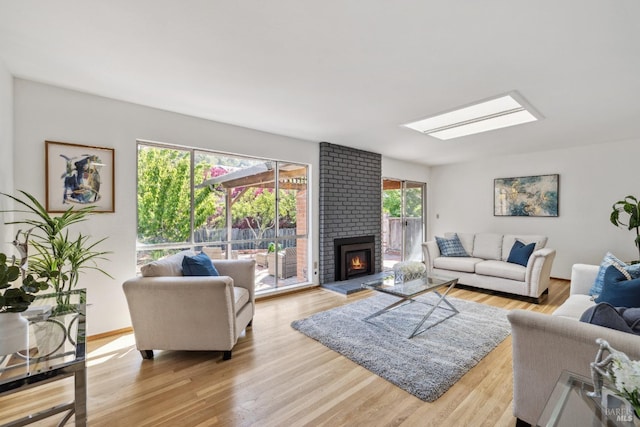 7 Hearthstone Ct, San Rafael, CA 94903 - living area featuring light wood-style flooring, a skylight, and a brick fireplace