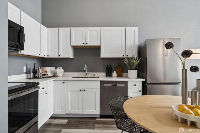 175 Bluxome St Unit 202, San Francisco, CA 94107 - kitchen featuring appliances with stainless steel finishes, white cabinetry, light countertops, and dark wood finished floors