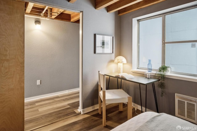 175 Bluxome St Unit 202, San Francisco, CA 94107 - bedroom featuring wood finished floors, beam ceiling, and a textured wall