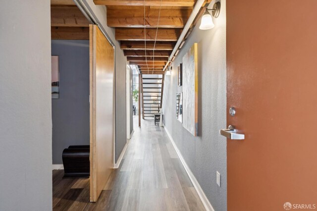 175 Bluxome St Unit 202, San Francisco, CA 94107 - hallway with wood finished floors, beam ceiling, and a textured wall
