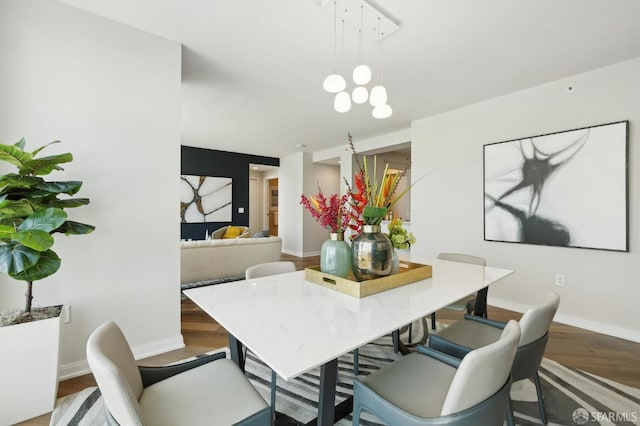 dining room with baseboards and wood finished floors