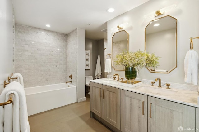 full bathroom featuring double vanity, a sink, tile patterned floors, and toilet
