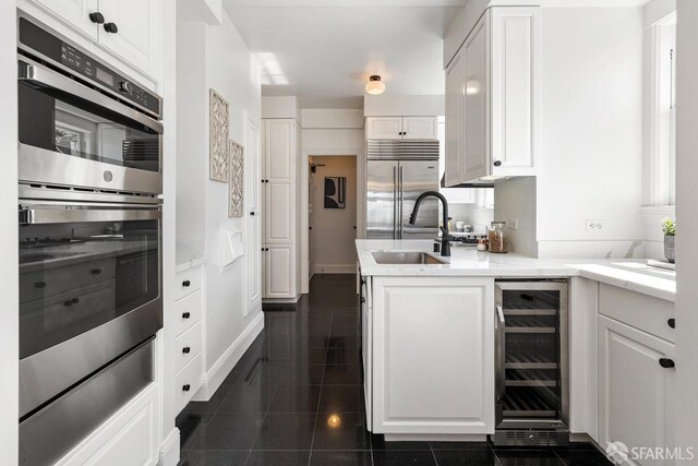 1998 Vallejo St Unit 2, San Francisco, CA 94123 - kitchen featuring wine cooler, stainless steel appliances, white cabinets, and light stone countertops