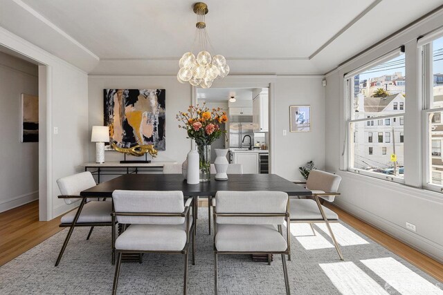 1998 Vallejo St Unit 2, San Francisco, CA 94123 - dining room with light wood-style flooring, a chandelier, a raised ceiling, and beverage cooler