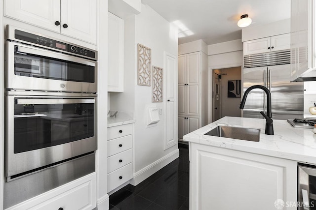 1998 Vallejo St Unit 2, San Francisco, CA 94123 - kitchen with appliances with stainless steel finishes, white cabinetry, light stone counters, and beverage cooler