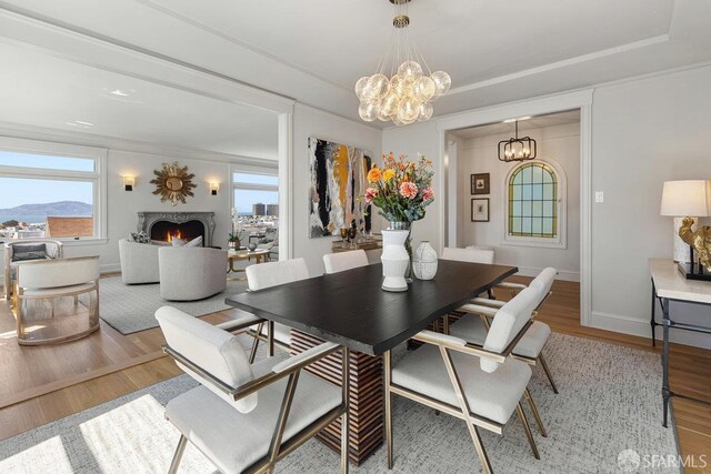 1998 Vallejo St Unit 2, San Francisco, CA 94123 - dining space featuring a chandelier, wood finished floors, and a lit fireplace