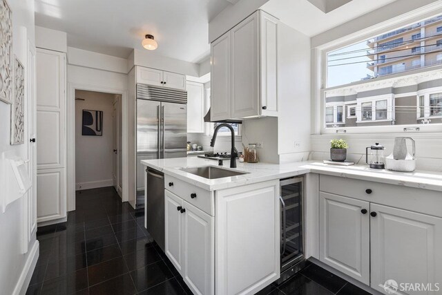 1998 Vallejo St Unit 2, San Francisco, CA 94123 - kitchen with beverage cooler, white cabinetry, stainless steel appliances, and light stone counters