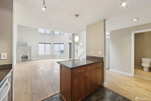 kitchen featuring hanging light fixtures, dishwasher, hardwood / wood-style flooring, and kitchen peninsula