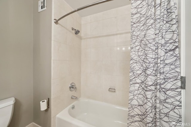 bathroom with shower / bath combination with curtain and toilet