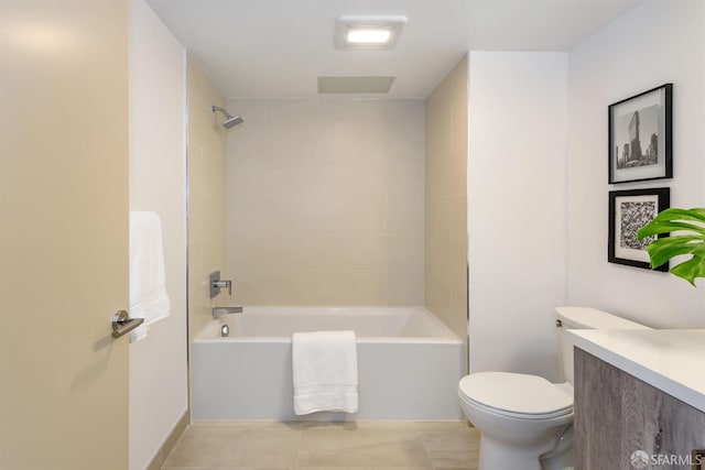 full bathroom with tile patterned floors, tiled shower / bath combo, toilet, and vanity