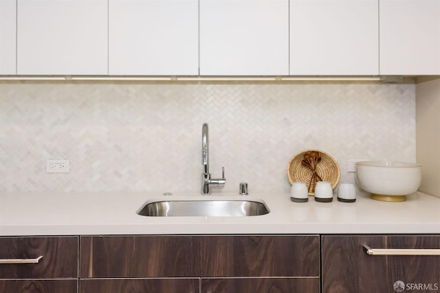 details with sink, white cabinets, and dark brown cabinets