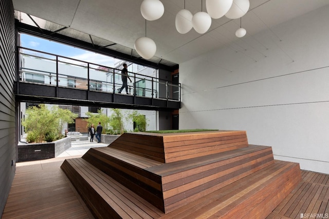 stairway featuring a high ceiling and hardwood / wood-style flooring