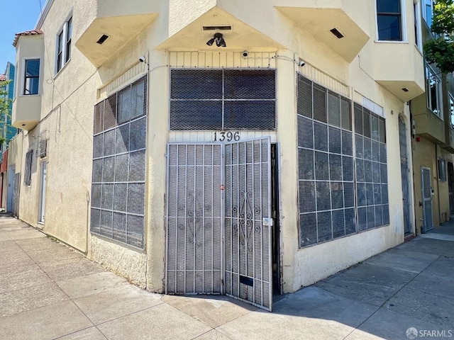 property entrance with stucco siding