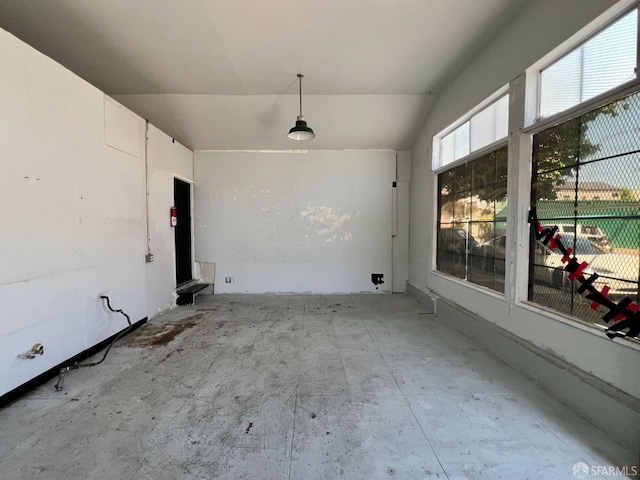 spare room featuring lofted ceiling