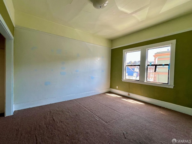 carpeted spare room with baseboards