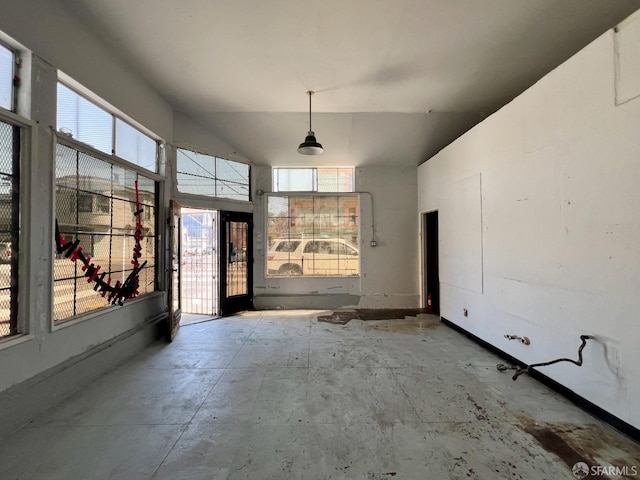 unfurnished dining area with plenty of natural light and vaulted ceiling