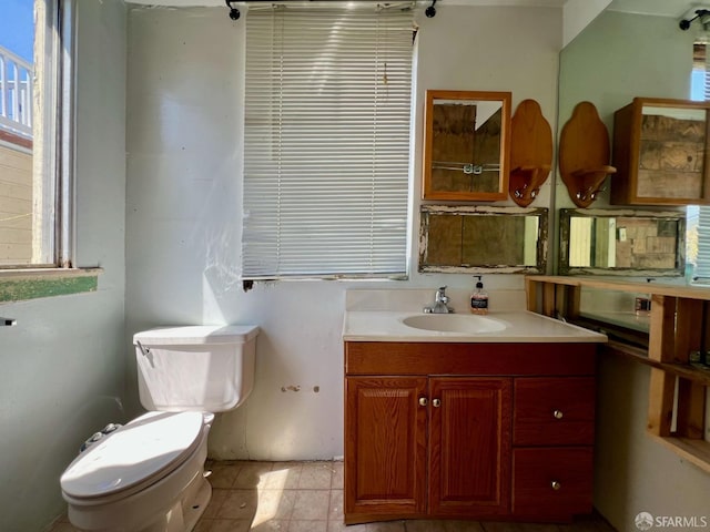 bathroom featuring toilet and vanity
