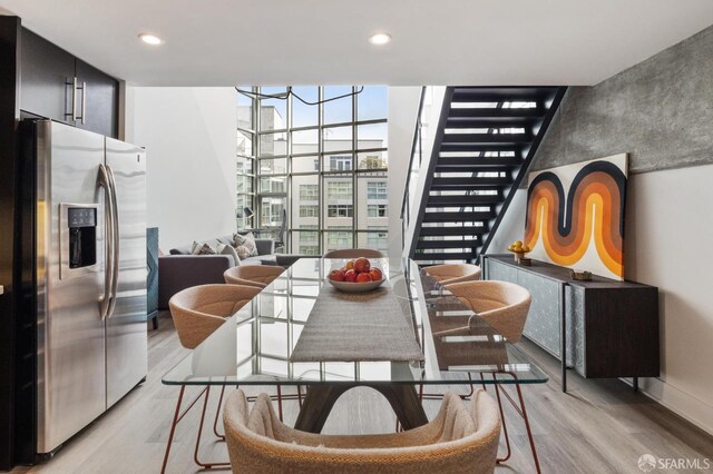 dining room featuring light hardwood / wood-style floors and a wall of windows