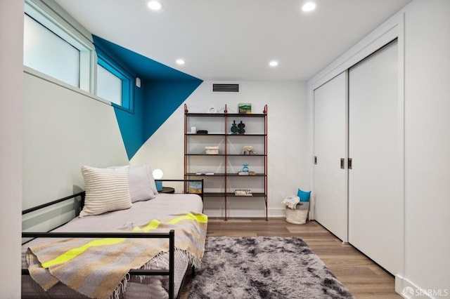 bedroom featuring hardwood / wood-style floors and a closet