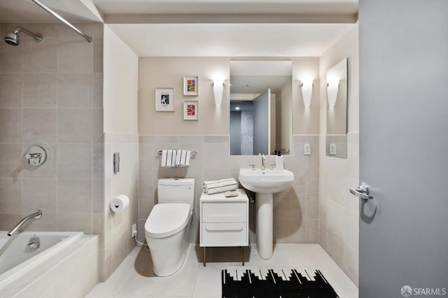 full bathroom featuring tiled shower / bath combo, sink, tile walls, tile patterned flooring, and toilet