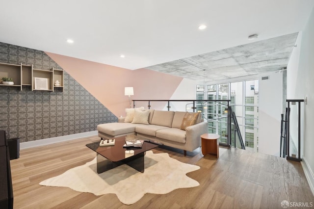 living room with floor to ceiling windows and light hardwood / wood-style flooring