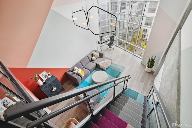 stairs featuring hardwood / wood-style floors and a towering ceiling