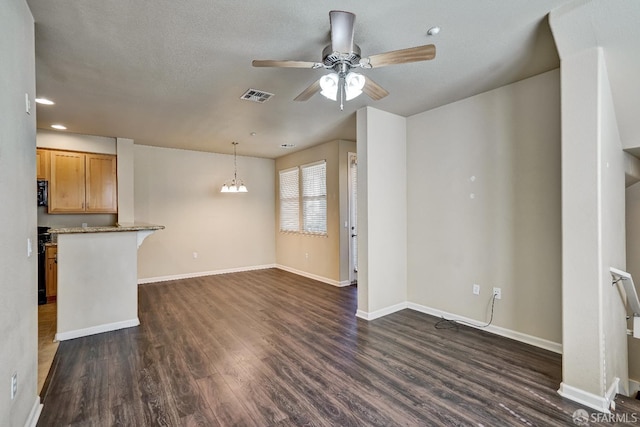 unfurnished living room with dark wood-type flooring, a ceiling fan, baseboards, and recessed lighting