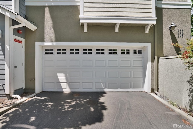 garage with asphalt driveway