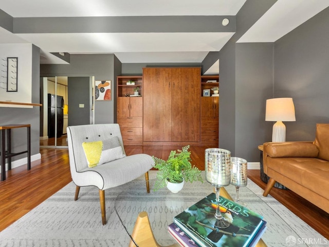 living room featuring wood finished floors and baseboards